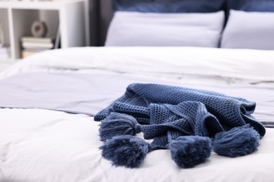 Soft blue plaid on bed in room, closeup