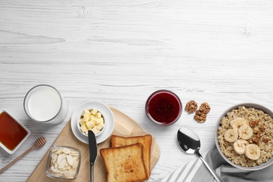Photo of Flat lay composition with tasty breakfast food on white wooden table. Space for text