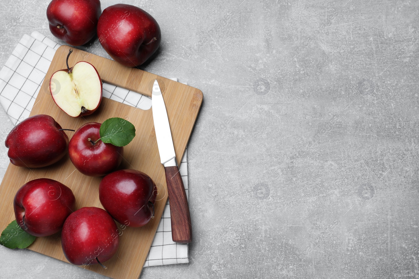 Photo of Fresh ripe red apples and knife on light grey table, flat lay. Space for text