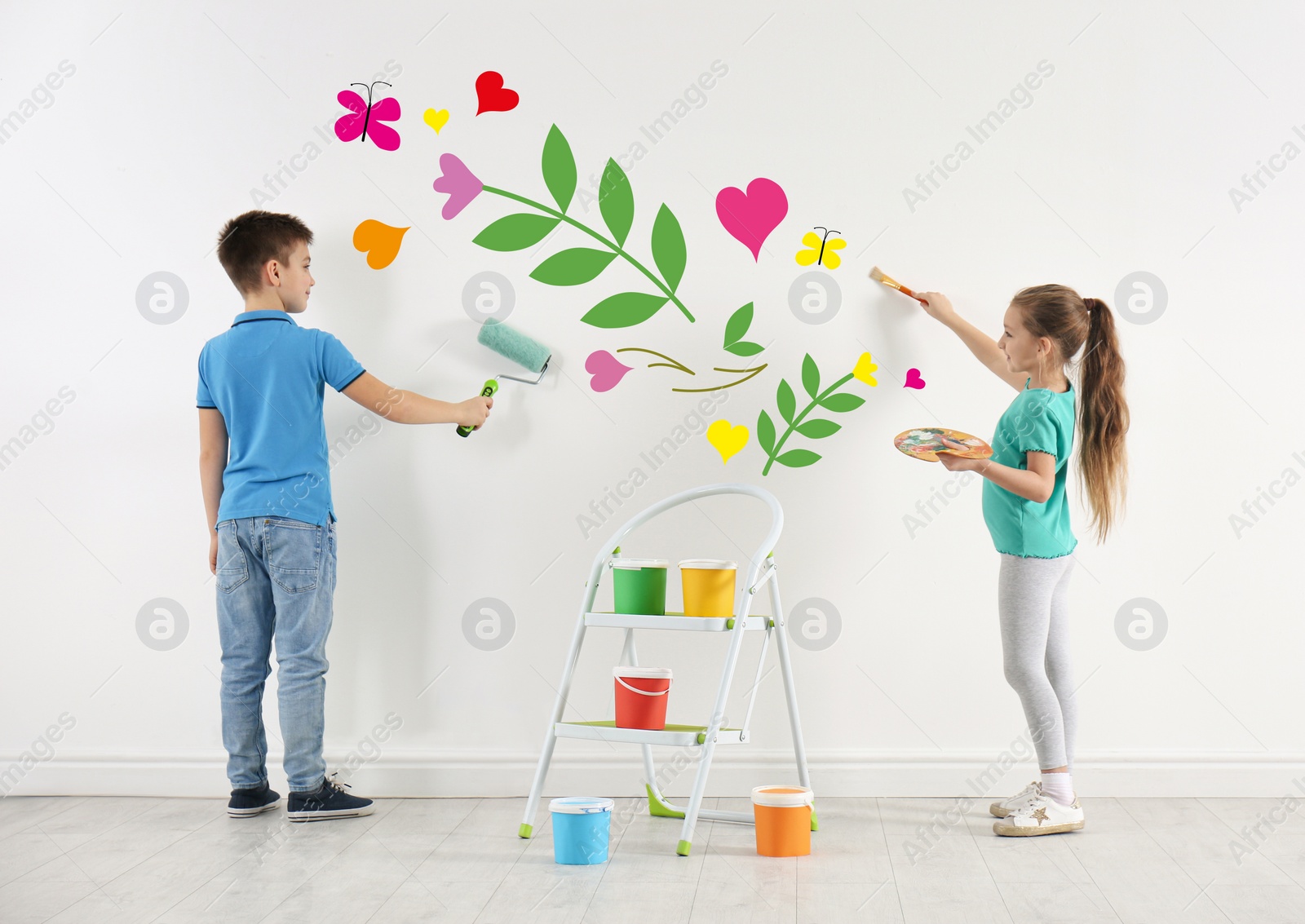 Image of Children drawing together on white wall indoors