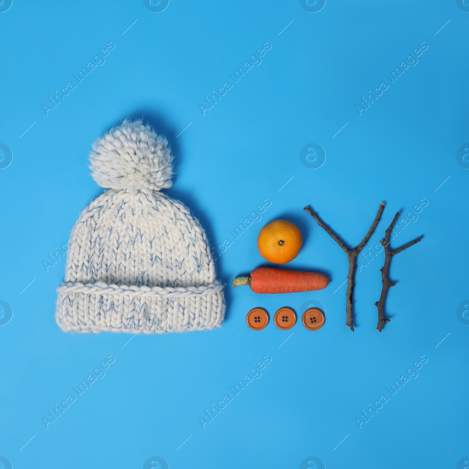 Photo of Set of materials for snowman on light blue background, flat lay