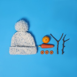 Photo of Set of materials for snowman on light blue background, flat lay