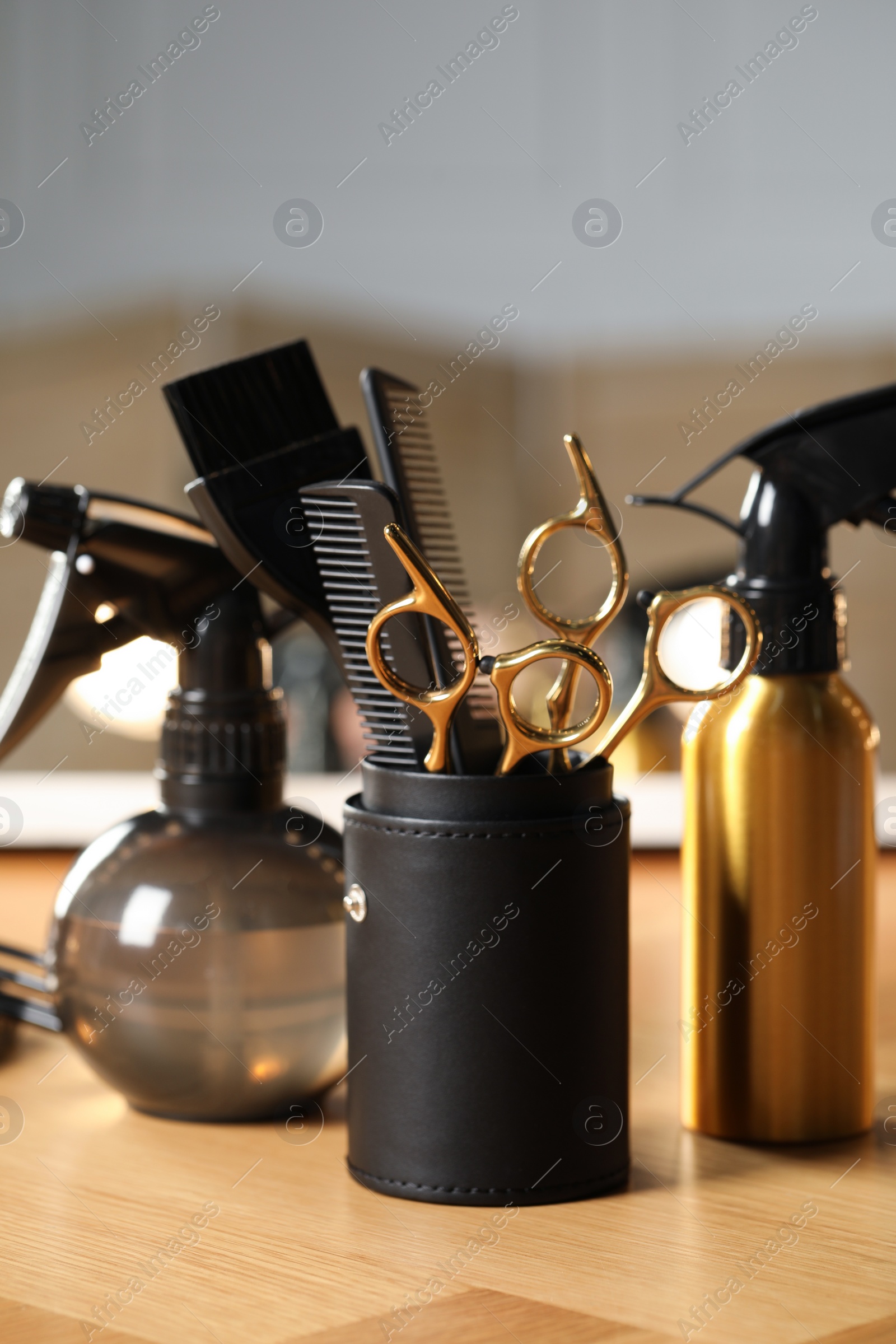 Photo of Set of hairdresser tools on table in salon