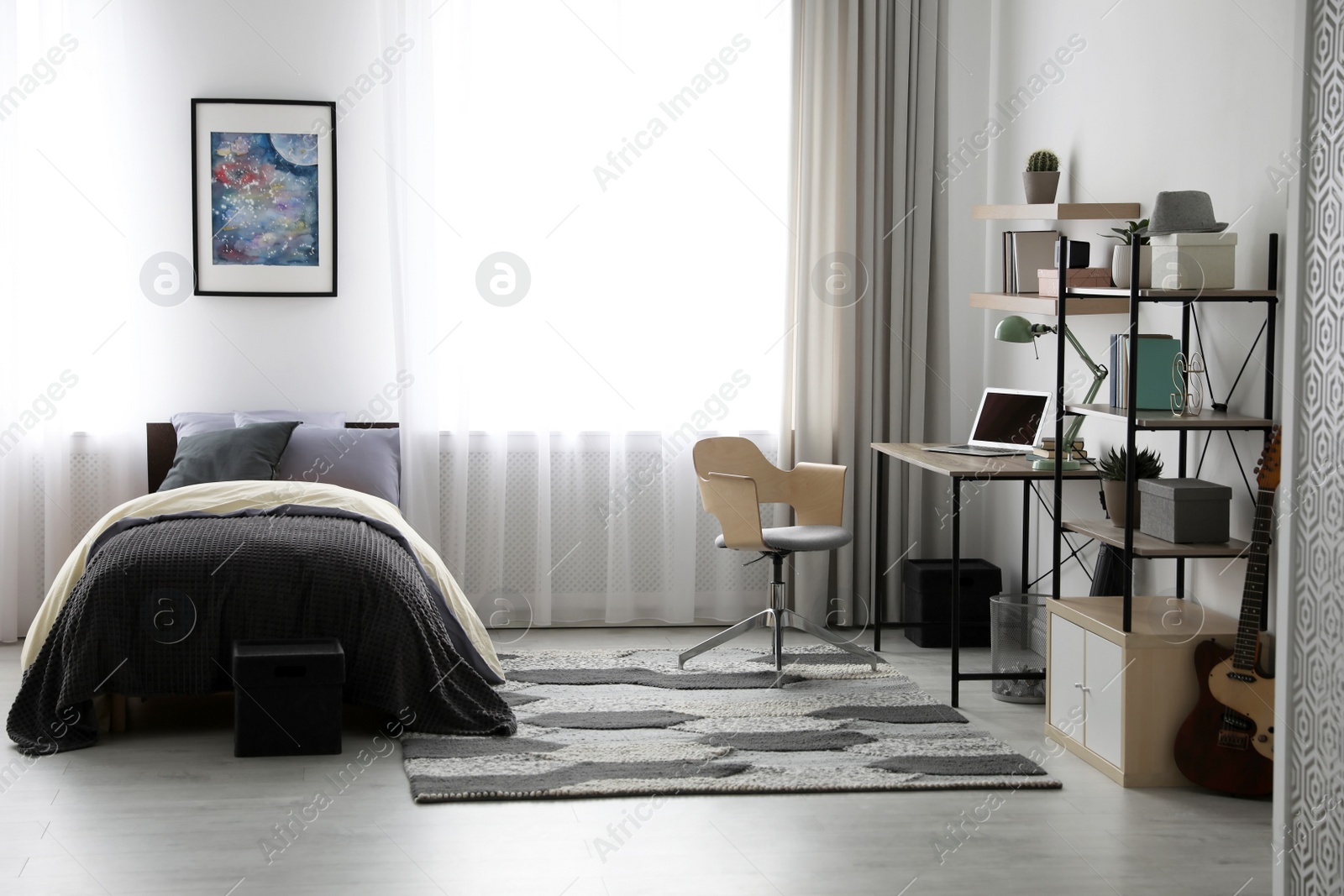 Photo of Modern teenager's room interior with workplace and bed