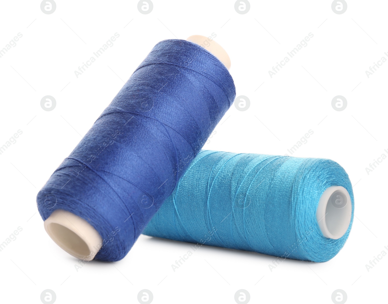 Photo of Different colorful sewing threads on white background