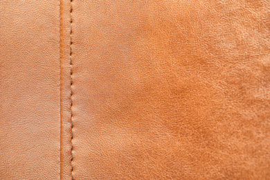 Texture of orange leather as background, closeup