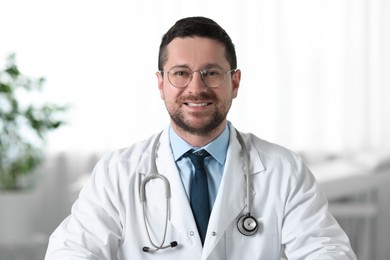 Photo of Portrait of smiling doctor with stethoscope in clinic