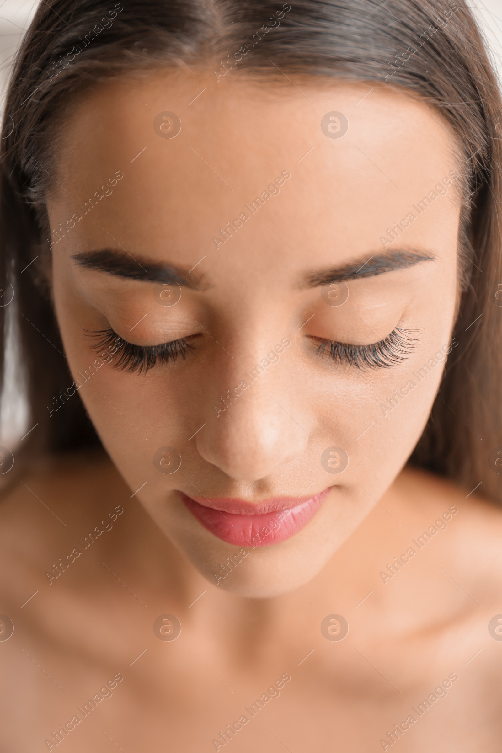 Photo of Attractive young woman with beautiful eyelashes, closeup