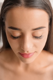 Attractive young woman with beautiful eyelashes, closeup