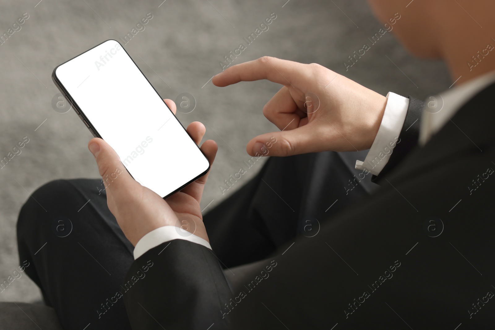 Photo of Man using smartphone with blank screen indoors, closeup. Mockup for design