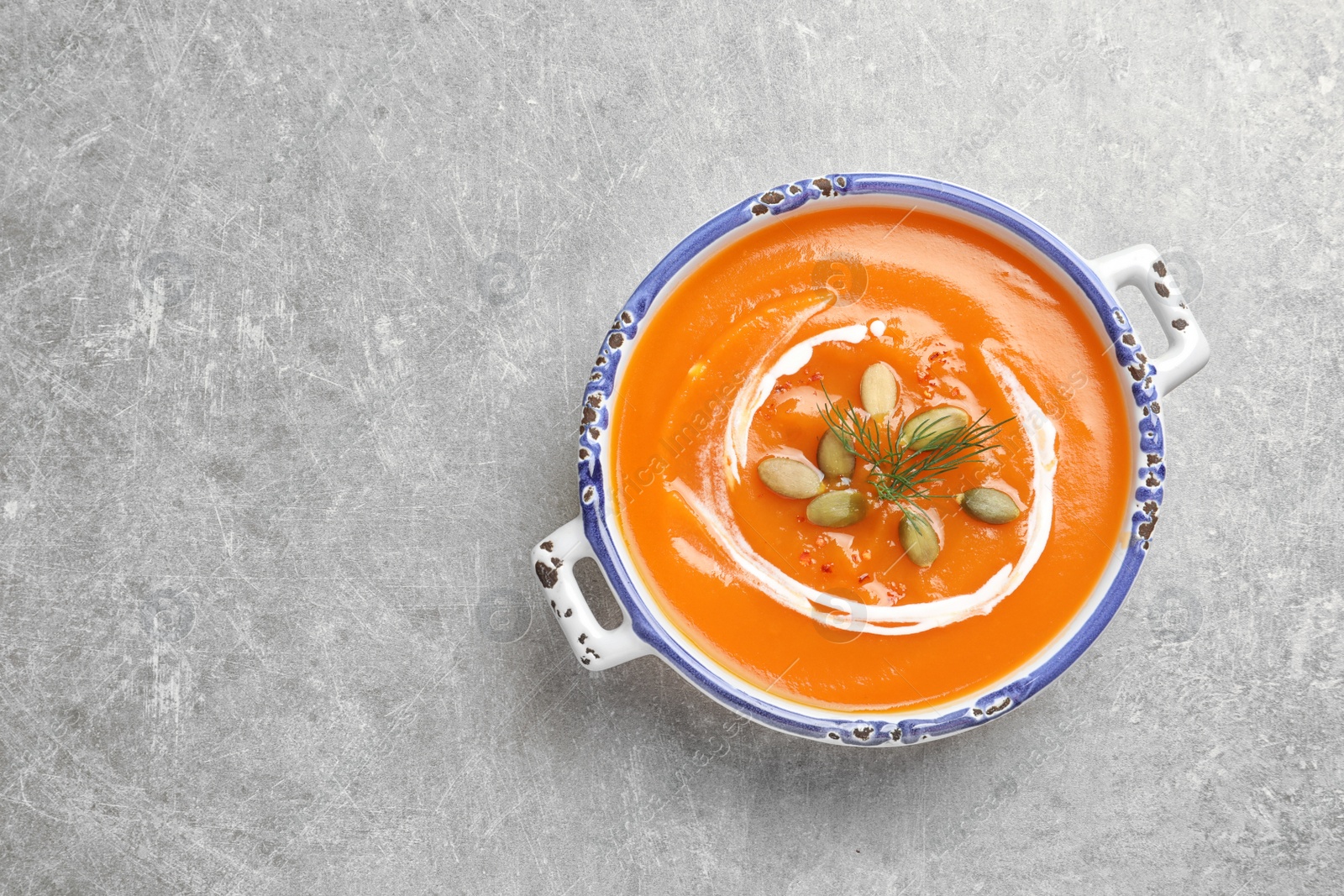 Photo of Bowl of tasty sweet potato soup on table, top view. Space for text