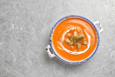 Bowl of tasty sweet potato soup on table, top view. Space for text