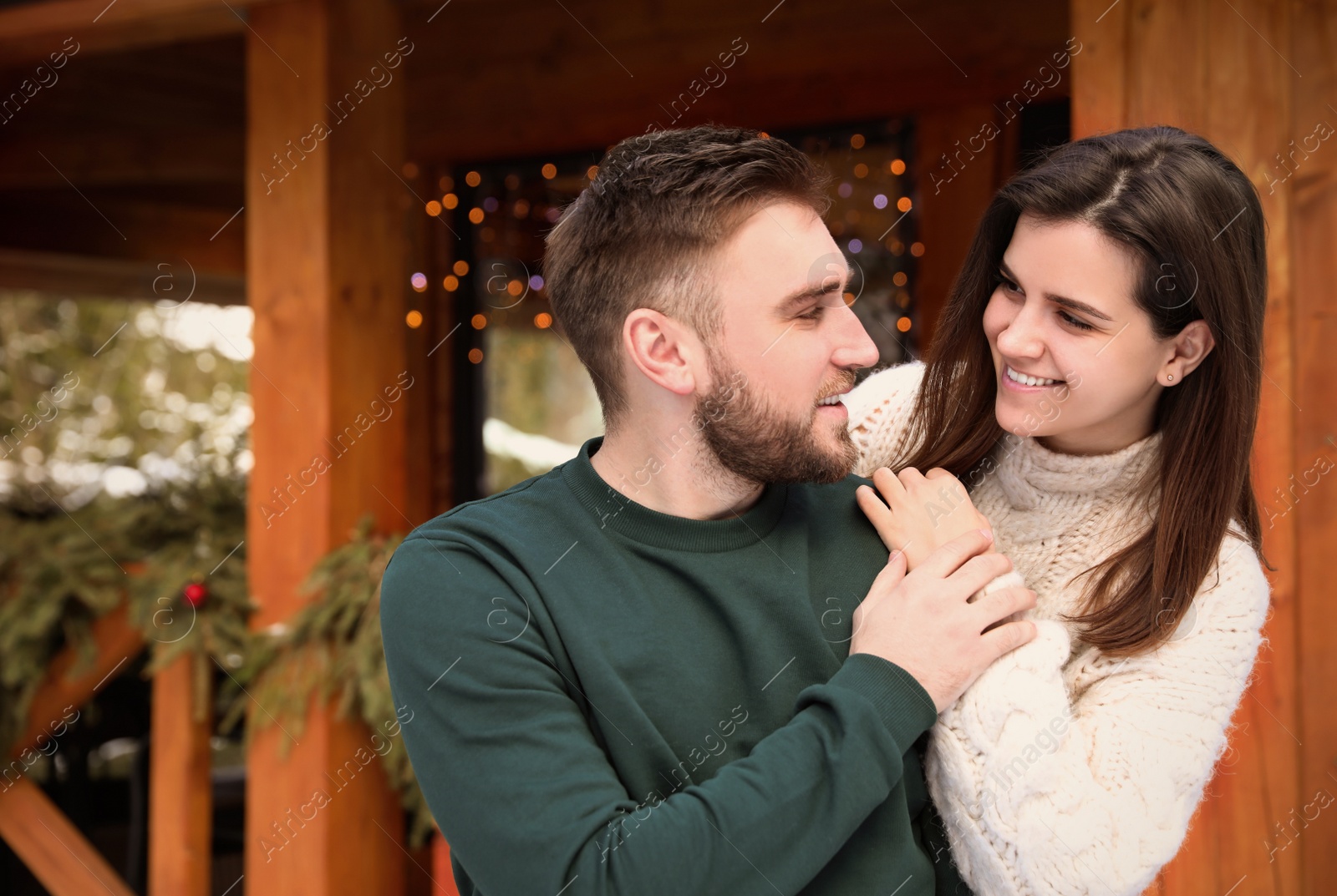 Photo of Happy couple in warm clothes outdoors. Winter vacation