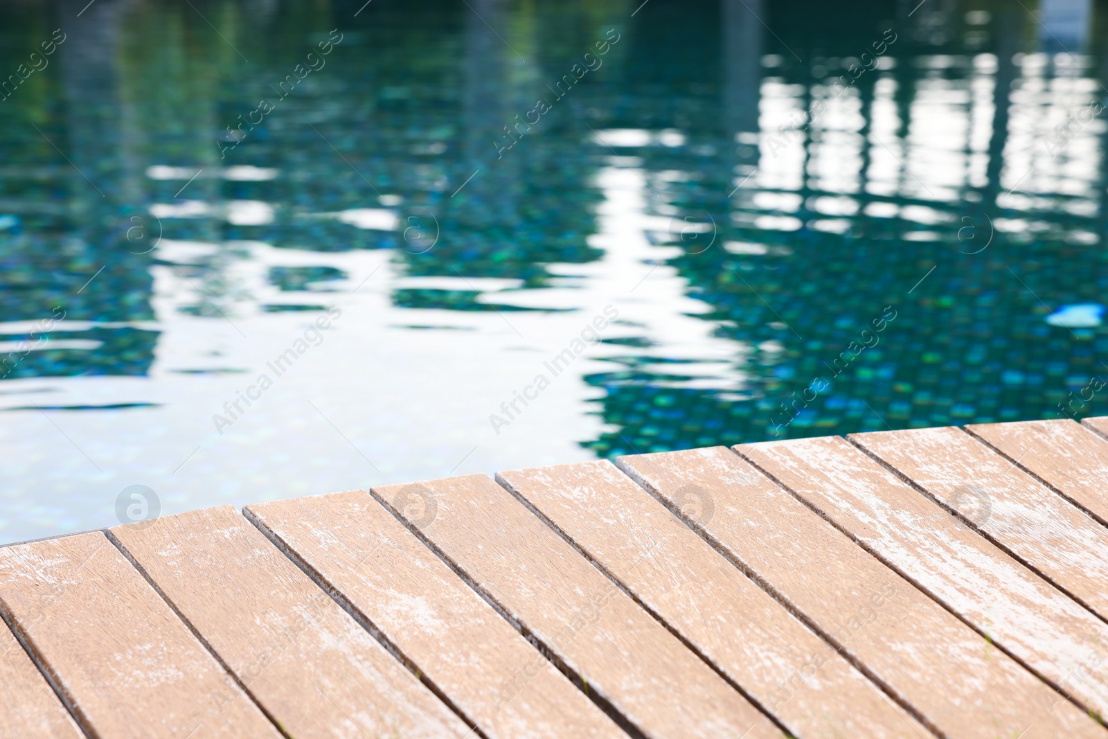 Photo of Outdoor swimming pool with wooden deck at resort