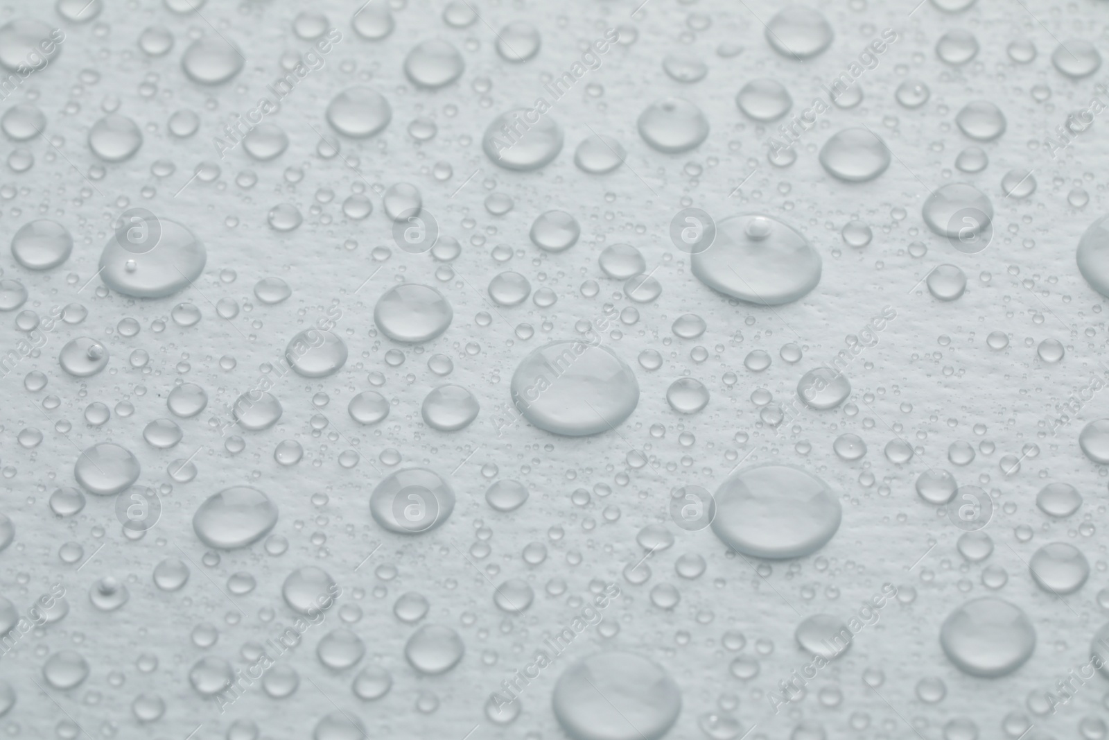 Photo of Water drops on white background, closeup view