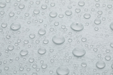 Photo of Water drops on white background, closeup view