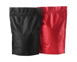 Photo of Black and red resealable foil packages isolated on white