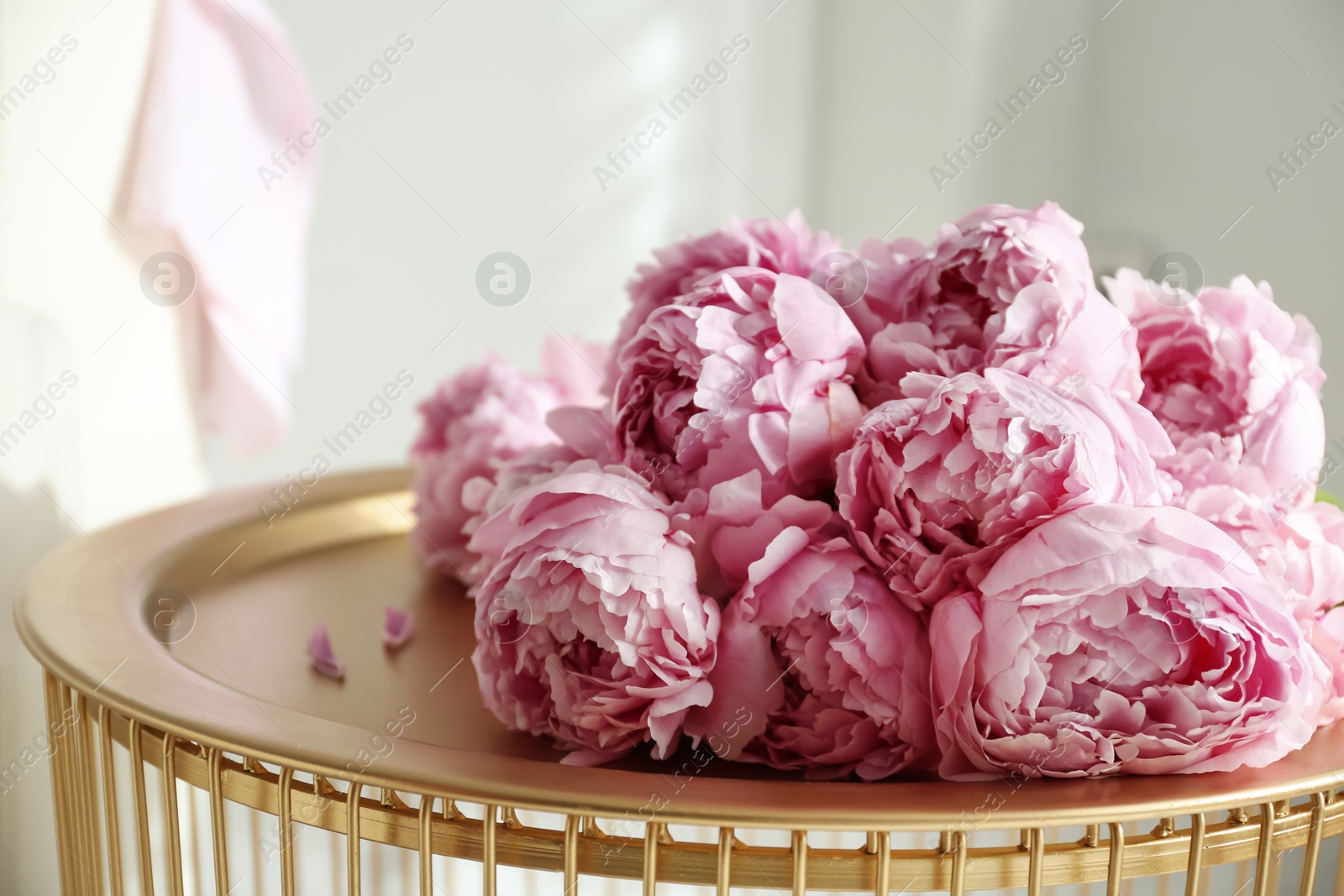 Photo of Bunch of beautiful peonies on table indoors, closeup