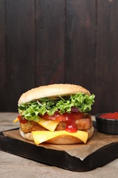 Photo of Delicious tofu burger served with sauce on wooden table