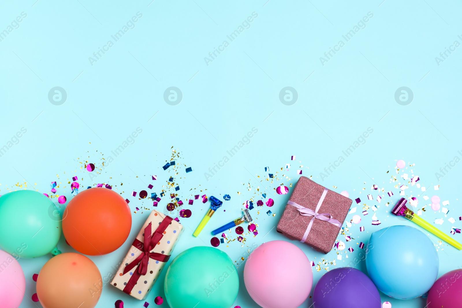 Photo of Flat lay composition with birthday decor on light blue background, space for text