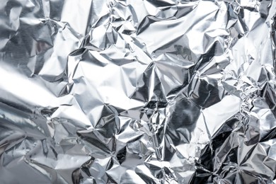 Crumpled silver foil as background, closeup view