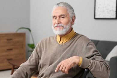 Photo of Portrait of handsome senior man at home