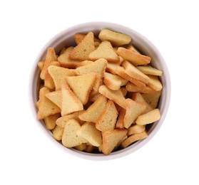 Delicious crispy rusks in bowl on white background, top view