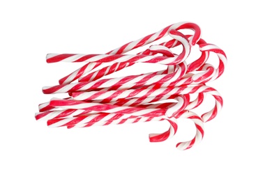 Sweet candy canes on white background, top view. Christmas treat 