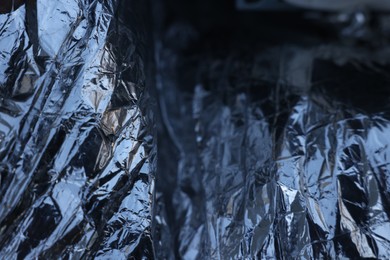 Texture of crumpled aluminum foil as background, closeup