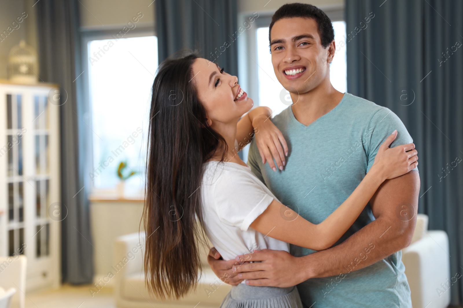 Photo of Lovely young interracial couple dancing at home