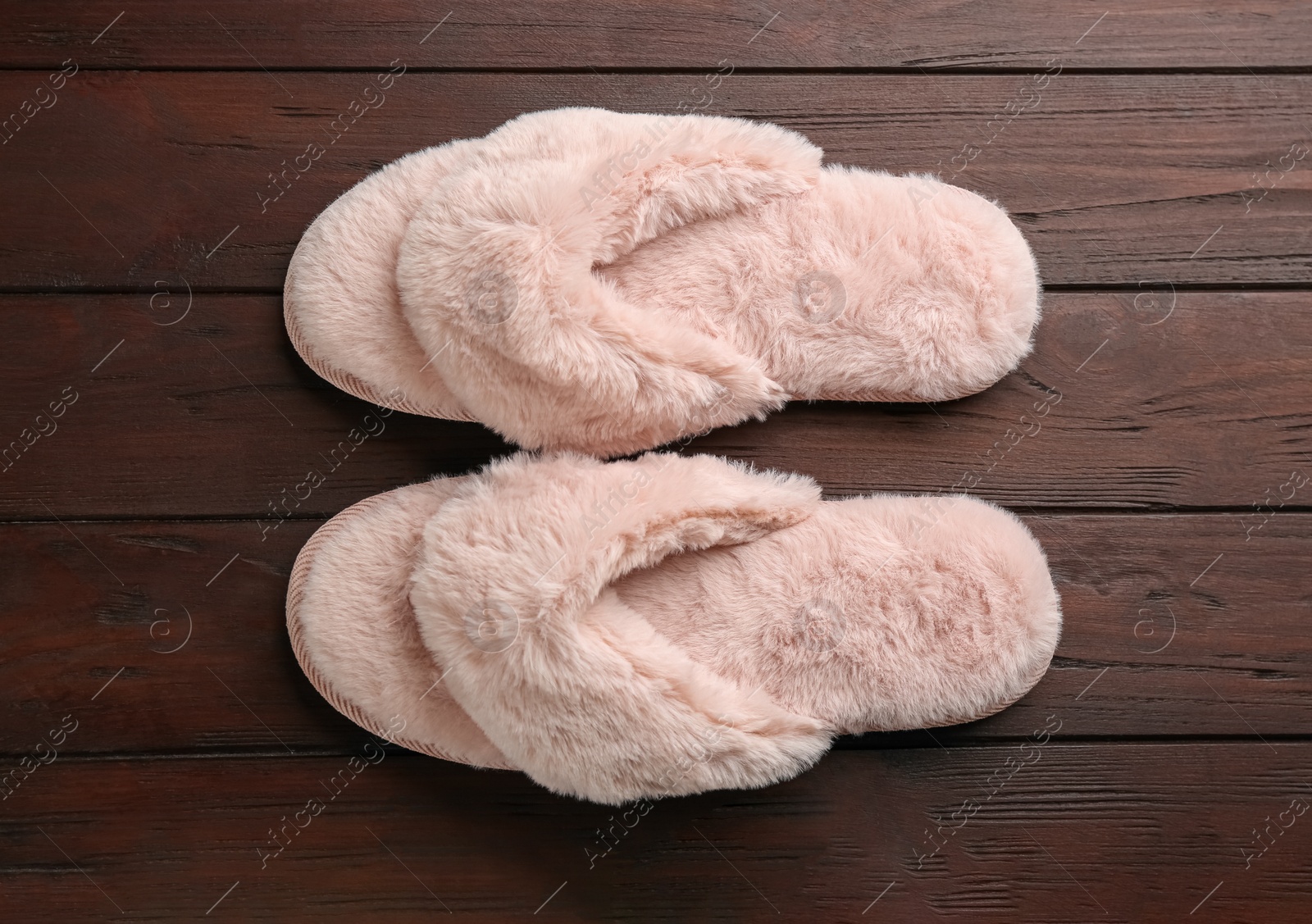 Photo of Pair of stylish soft slippers on wooden background, flat lay