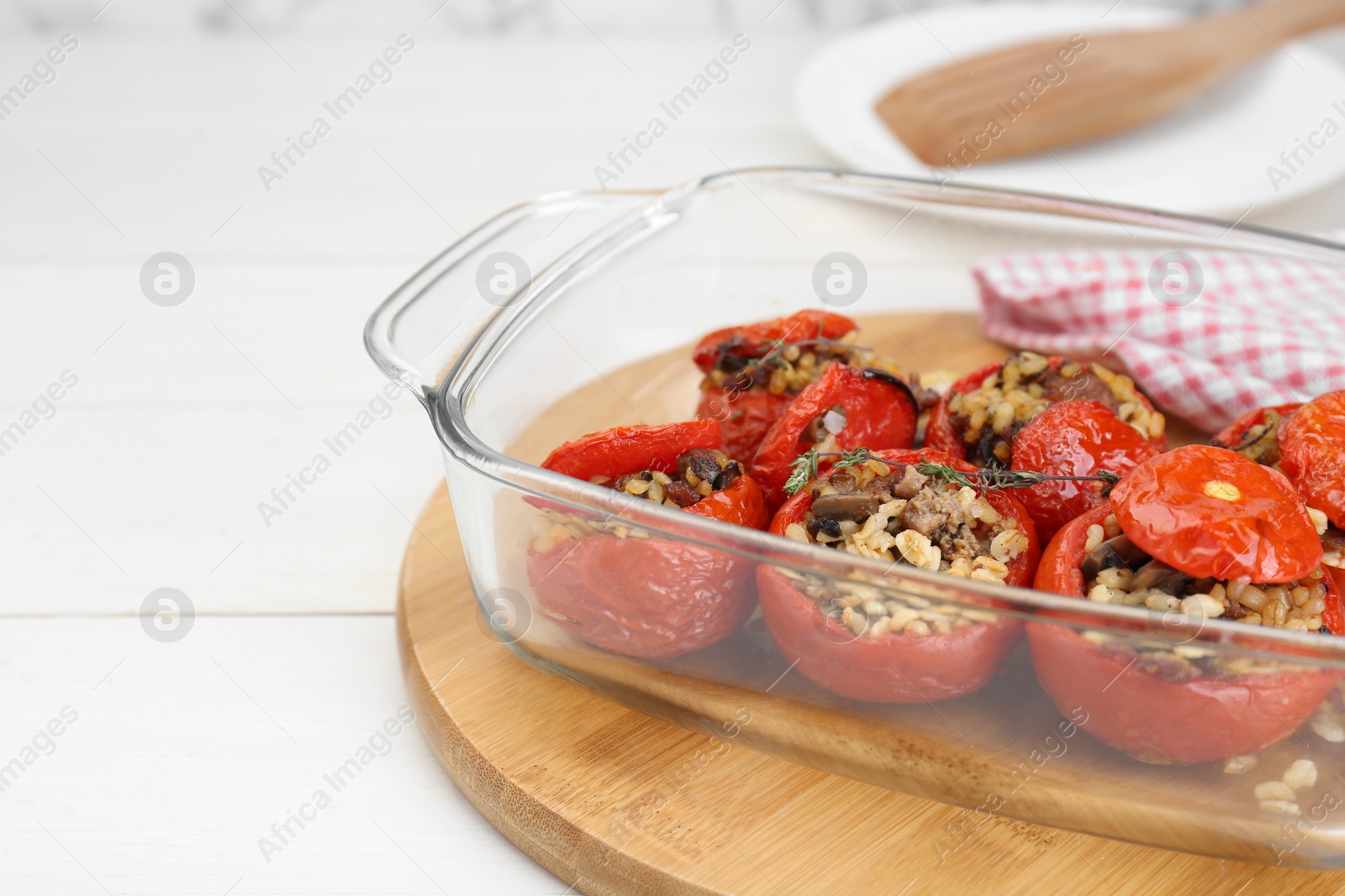 Photo of Delicious stuffed tomatoes with minced beef, bulgur and mushrooms on white table, closeup