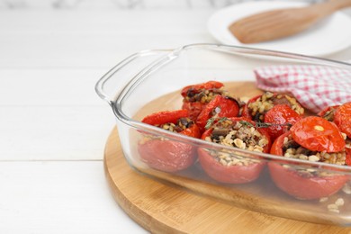 Delicious stuffed tomatoes with minced beef, bulgur and mushrooms on white table, closeup