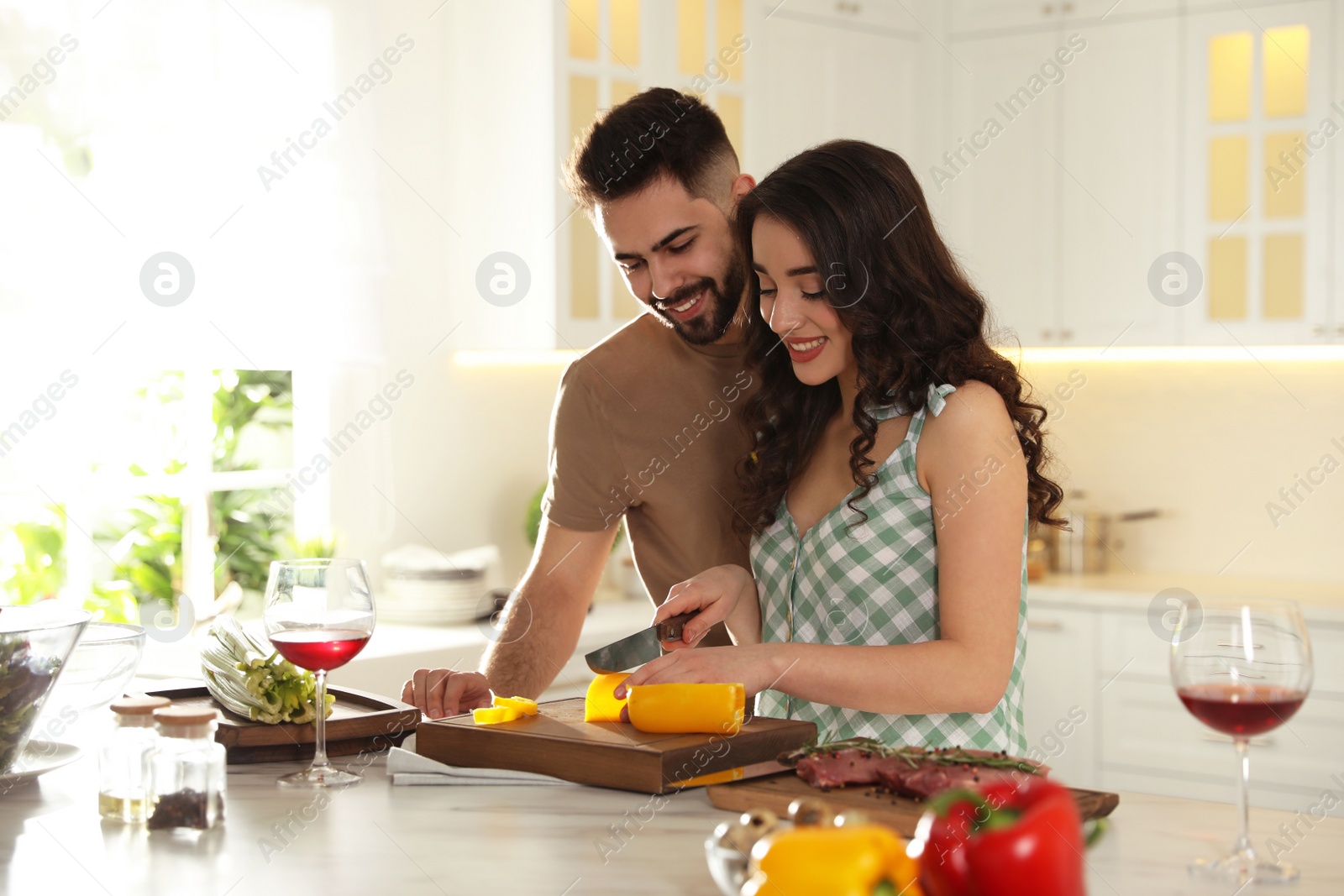 Photo of Lovely young couple cooking together in kitchen