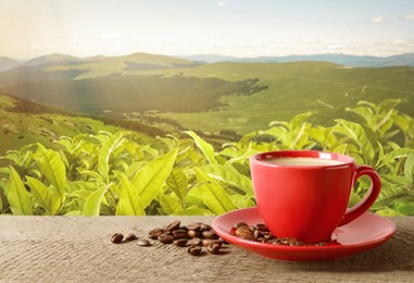 Image of Cup of aromatic hot coffee on wooden table and beautiful view of mountain landscape. Space for text