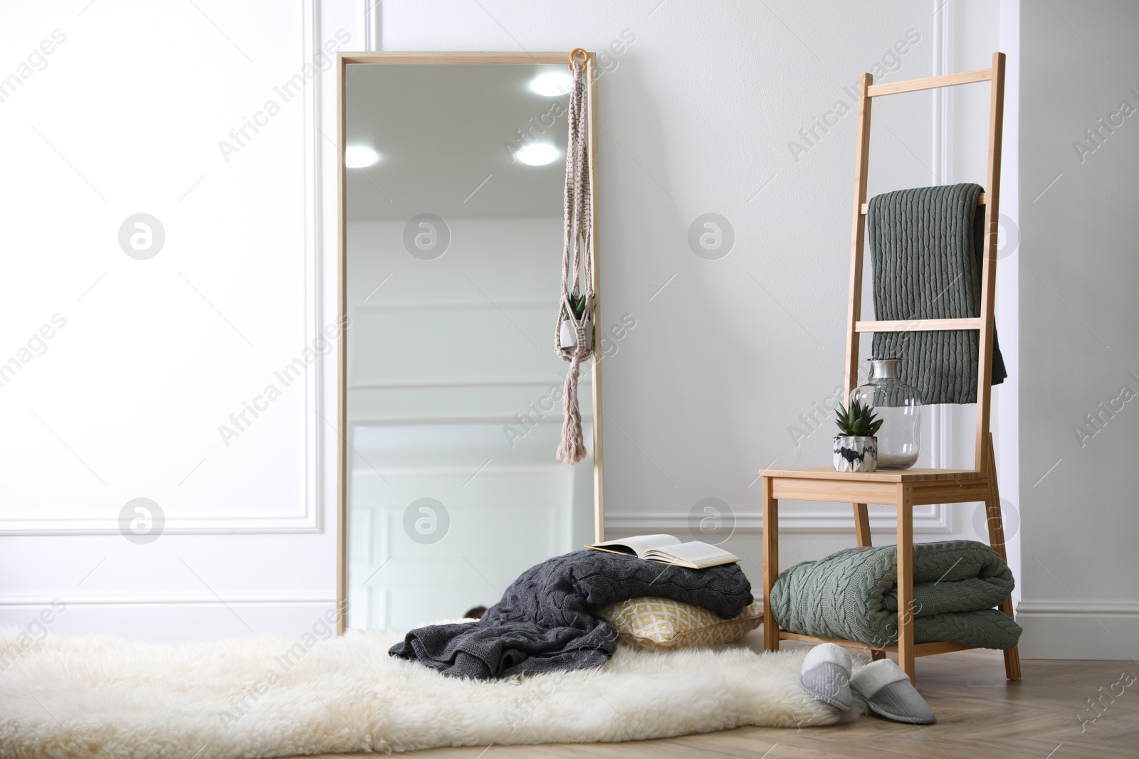 Photo of Comfortable place for rest with soft blankets and large mirror