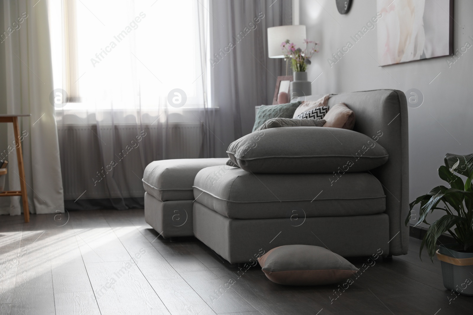 Photo of Elegant living room with comfortable sofa near window. Interior design