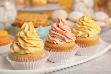 Photo of Tasty cupcakes and other sweets on table. Candy bar, closeup view