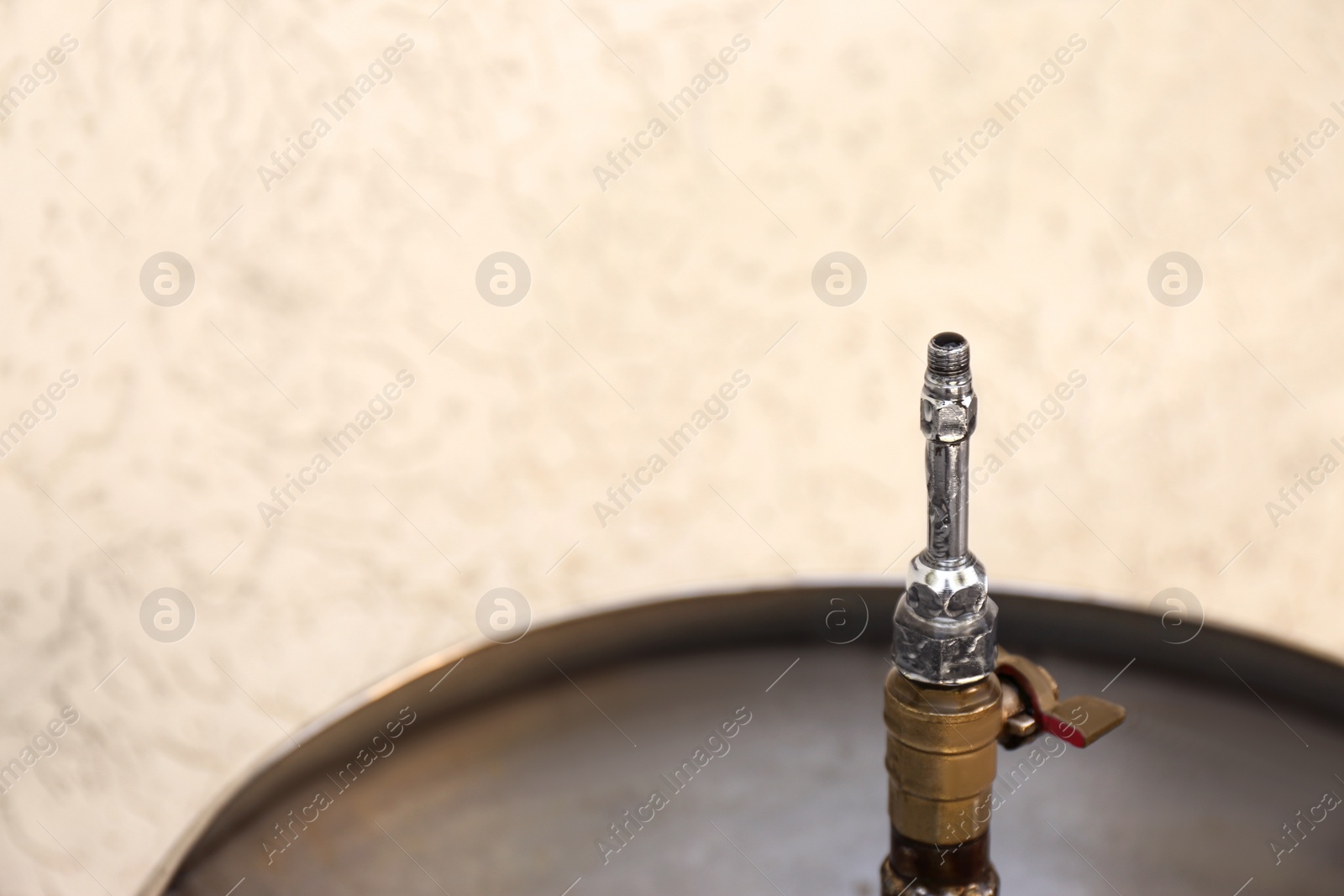 Photo of Drinking fountain with running water outdoors, closeup. Space for text