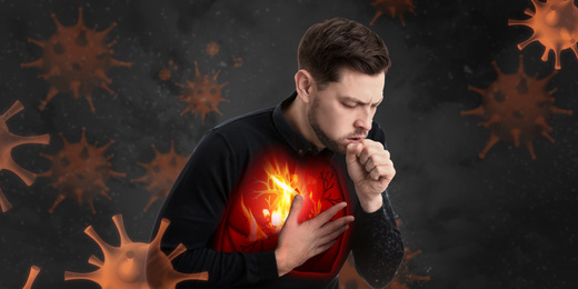 Image of Man with diseased lungs surrounded by viruses on dark background