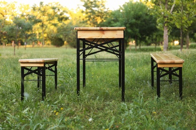 Photo of Wooden picnic table with benches in park