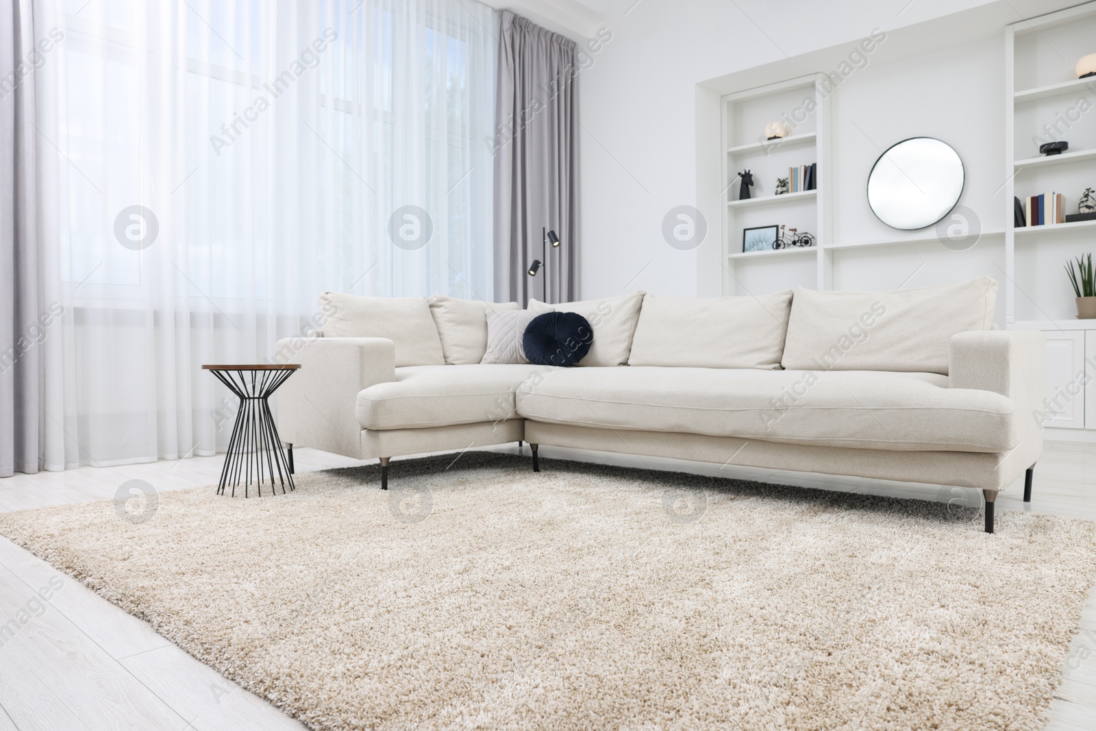 Photo of Fluffy carpet and stylish furniture on floor indoors