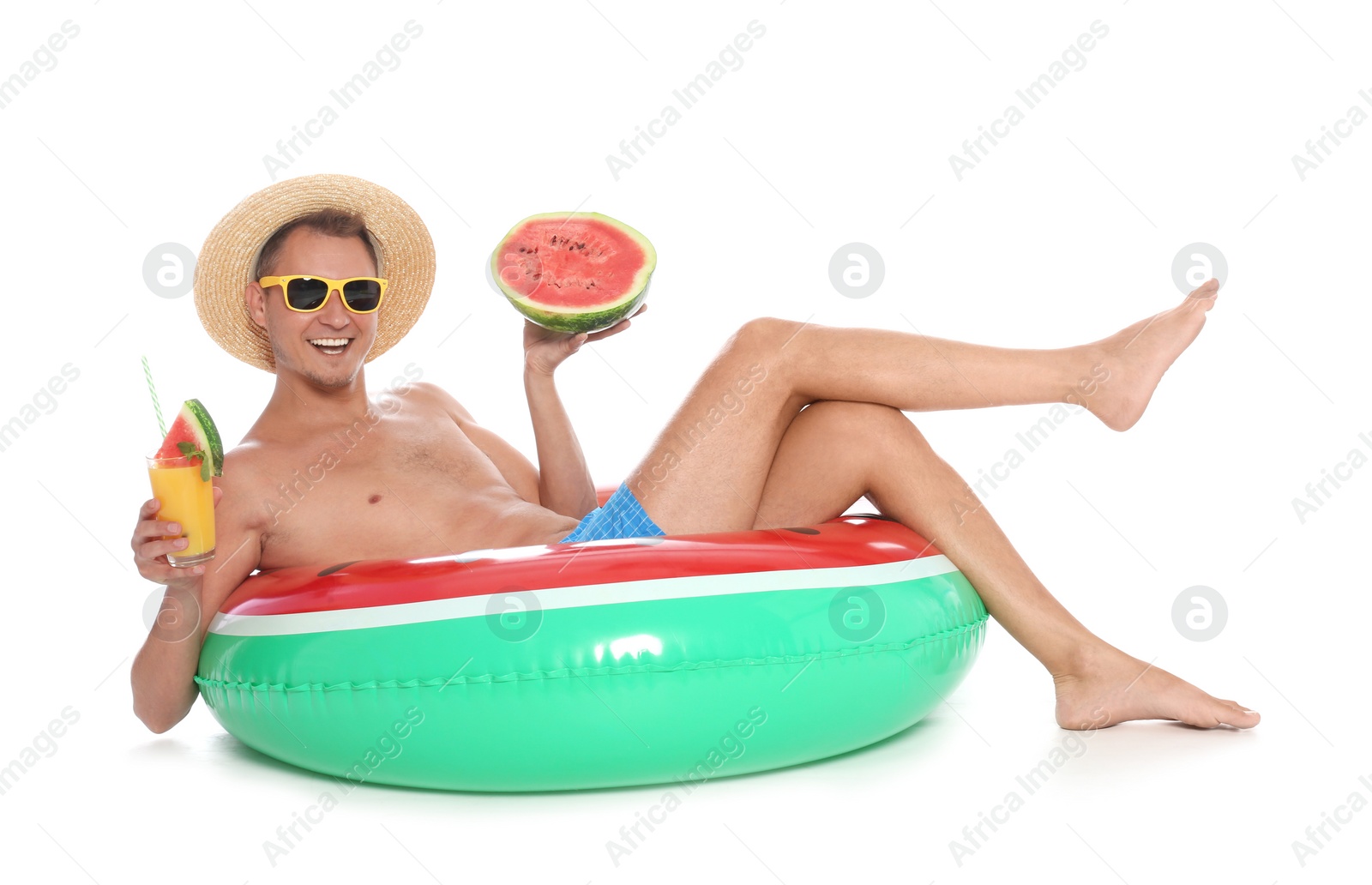Photo of Shirtless man with inflatable ring, watermelon and glass of cocktail on white background
