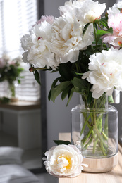 Bouquet of beautiful peony flowers on window sill indoors