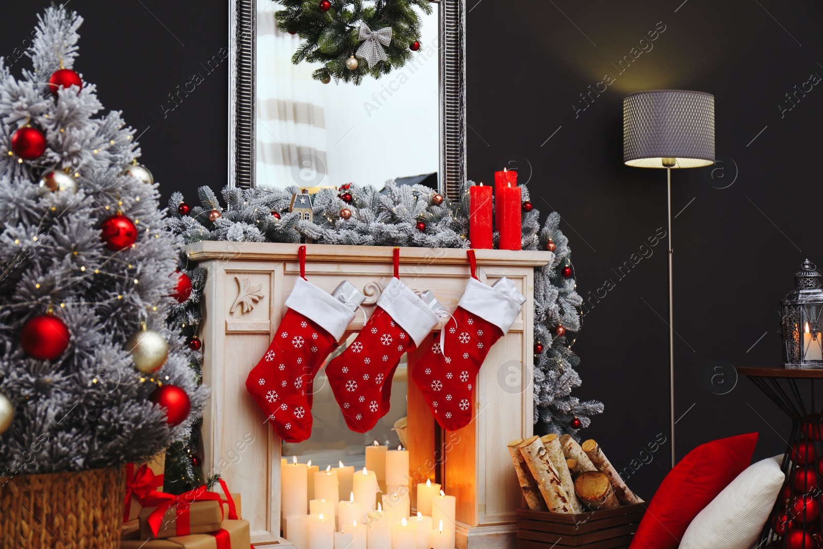 Photo of Fireplace with Christmas stockings in festive room interior