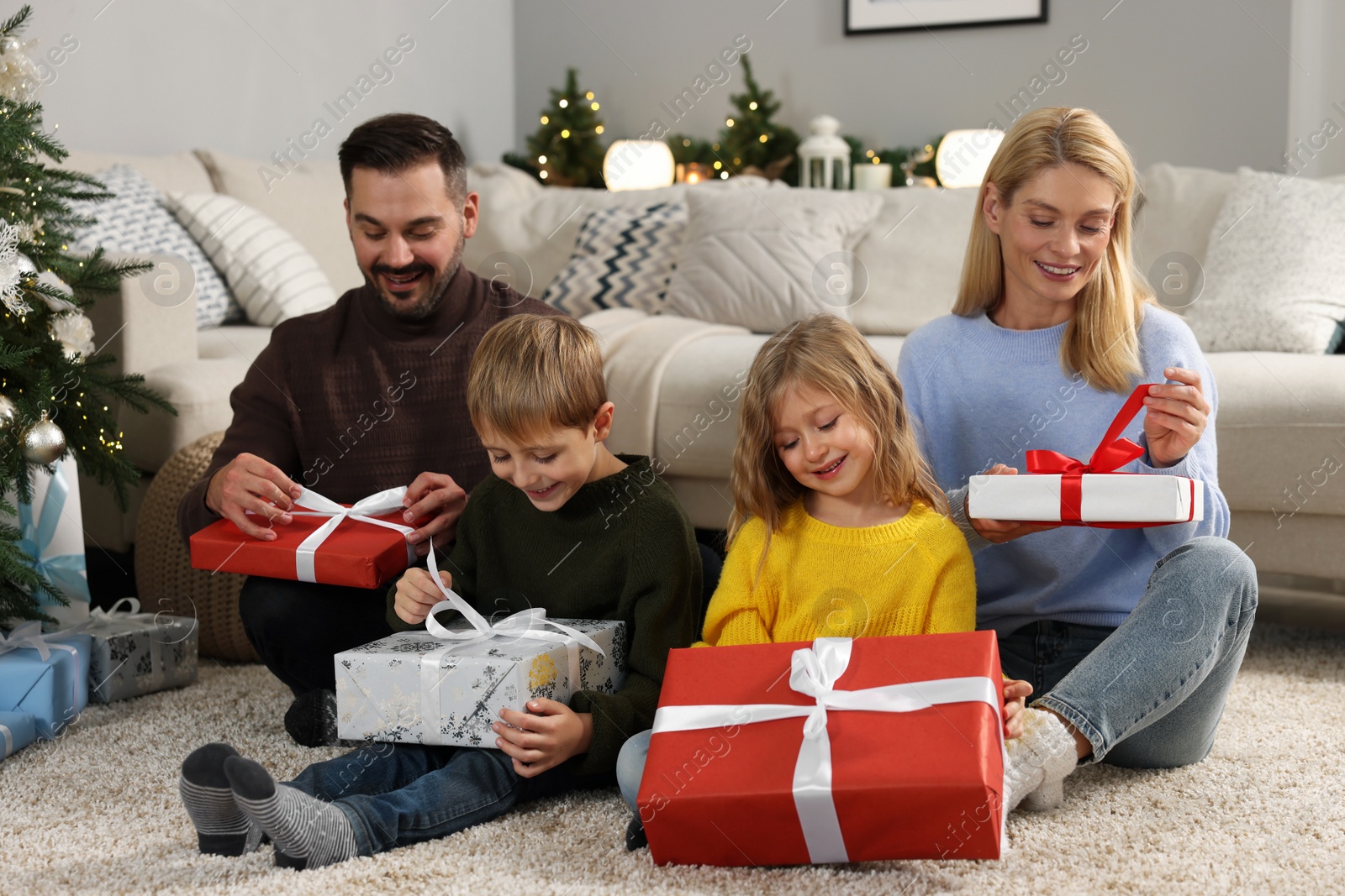 Photo of Happy family with Christmas gifts at home