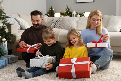 Photo of Happy family with Christmas gifts at home