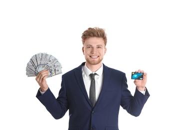 Happy young businessman with money and credit card on white background