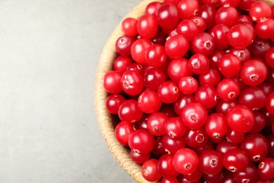 Photo of Tasty ripe cranberries on grey table, top view