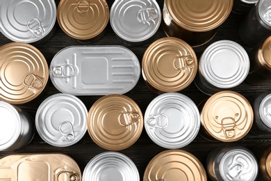 Many tin cans on wooden background, top view. Recycling garbage